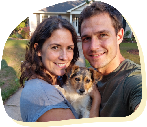 family with dog in front of their home