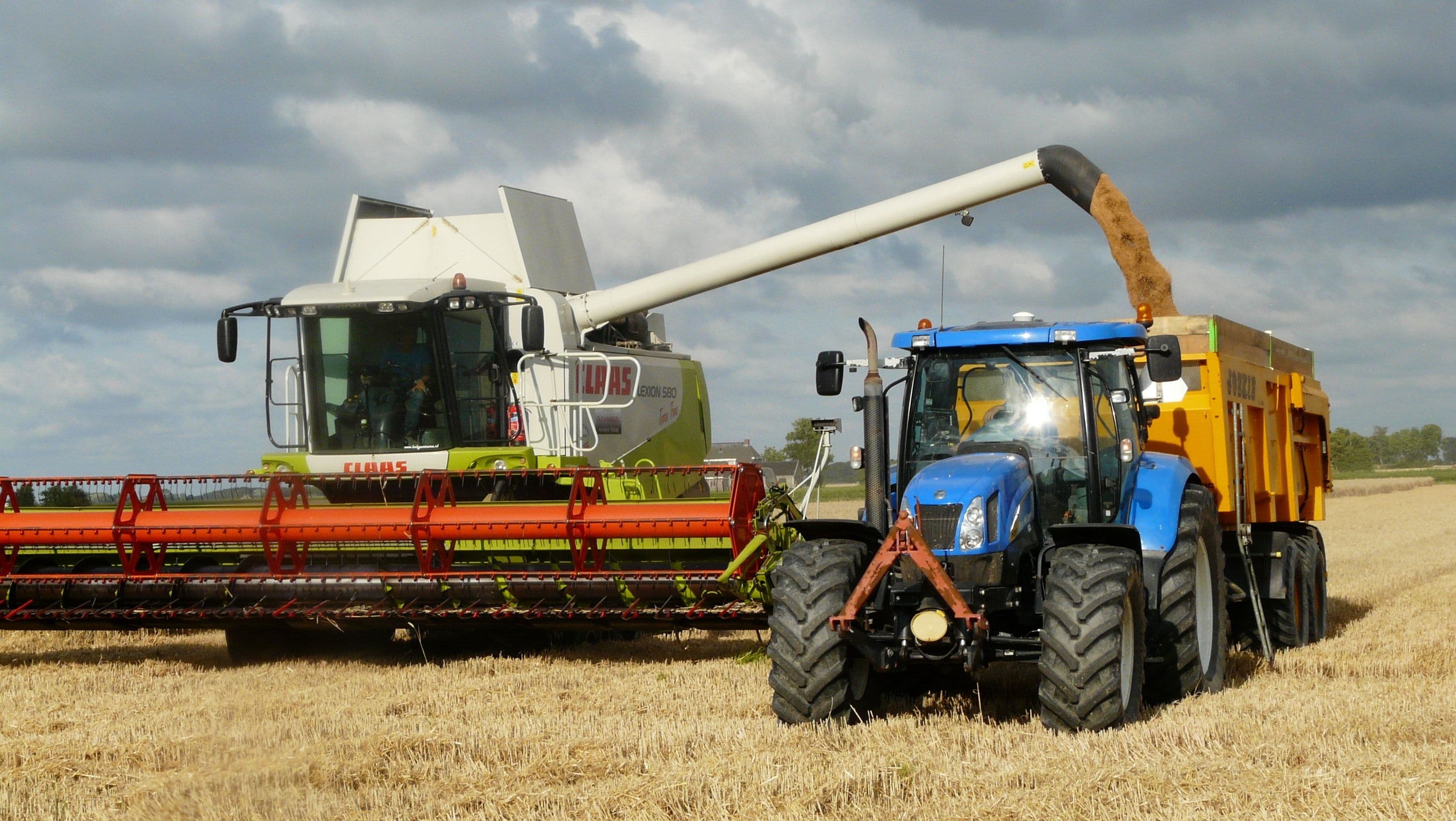 A tractor and a heavy farming vehicle