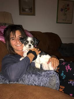 Tricia Greco hugging a dog