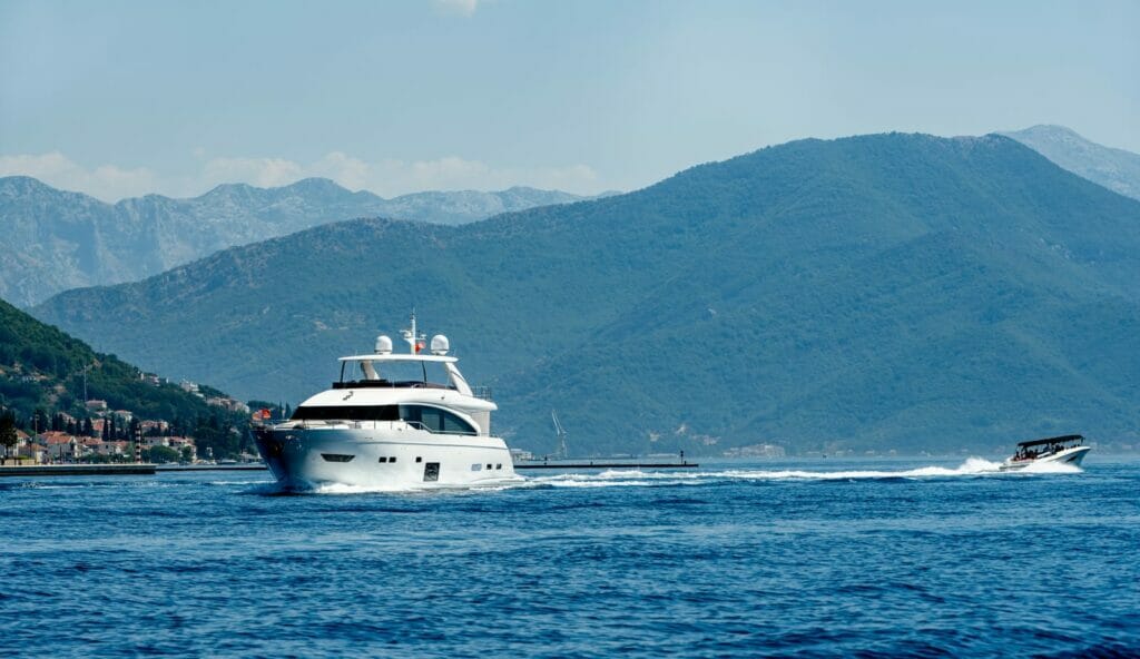 A boat in the water with mountains in the background.
