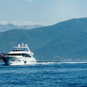 A boat in the water with mountains in the background.
