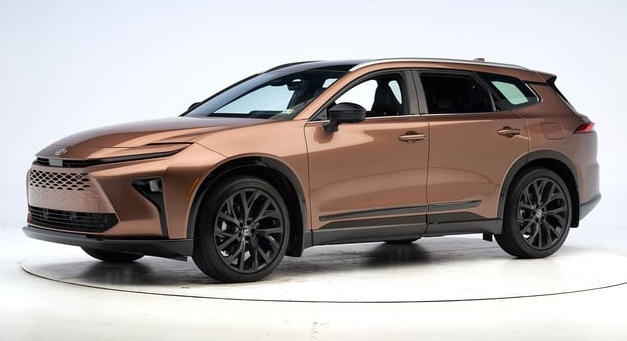 A bronze-colored SUV with sleek, modern styling, black trim, tinted windows, and large black wheels—one of the best vehicles for transporting dogs—shown in a studio with a plain white background.