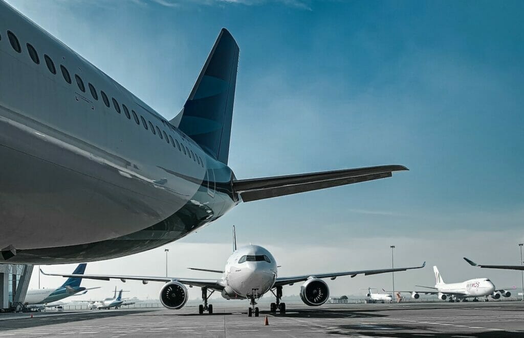 A group of airplanes parked on the tarmac showcasing Frontier Airlines' pet policy.