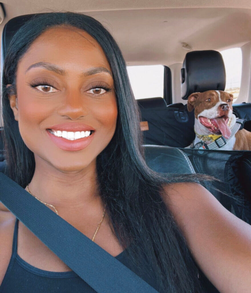 Nesta Howell, a CitizenShipper driver, transporting a dog in the back seat of her car.