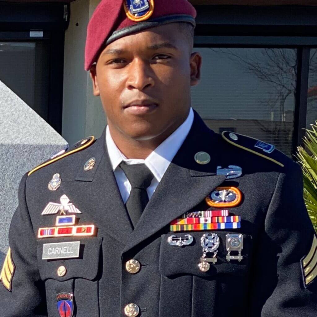 A CitizenShipper driver in a military uniform posing for a photo.